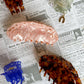 Set of hair claws on a newspaper background