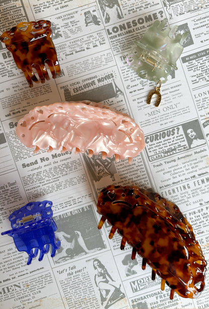 Set of hair claws on a newspaper background